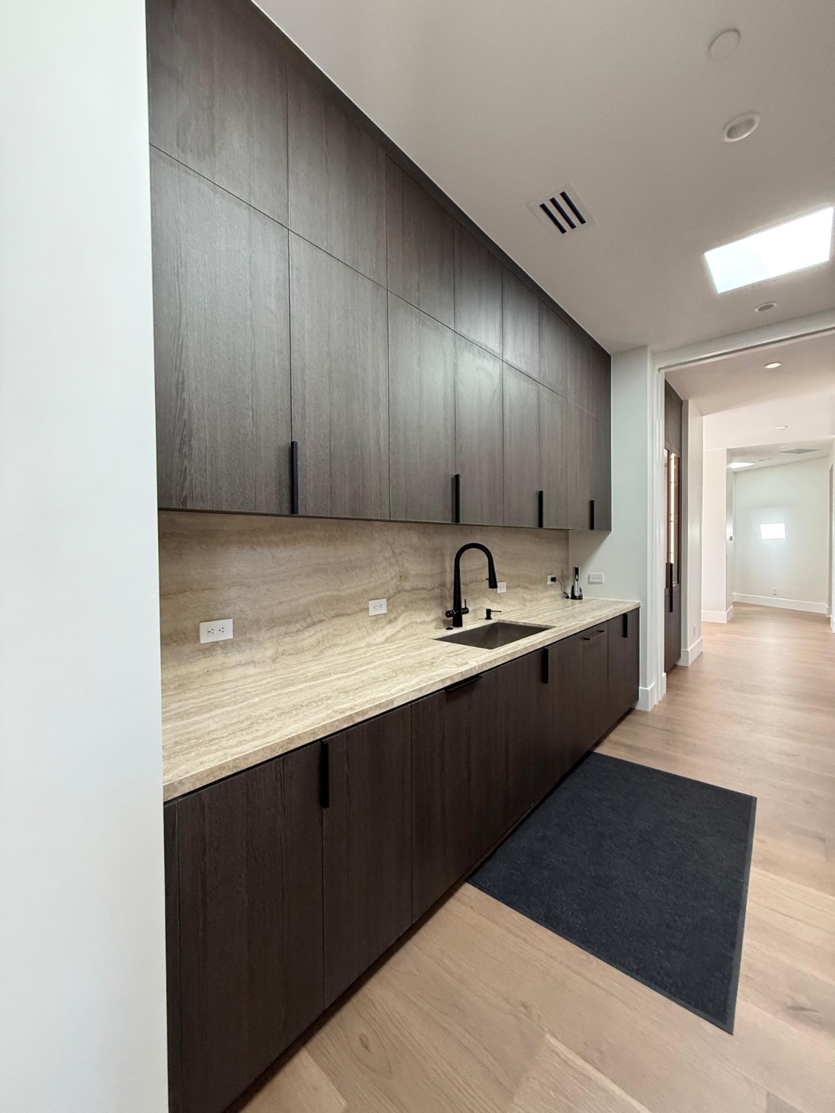 Modern butler pantry with travertine counter