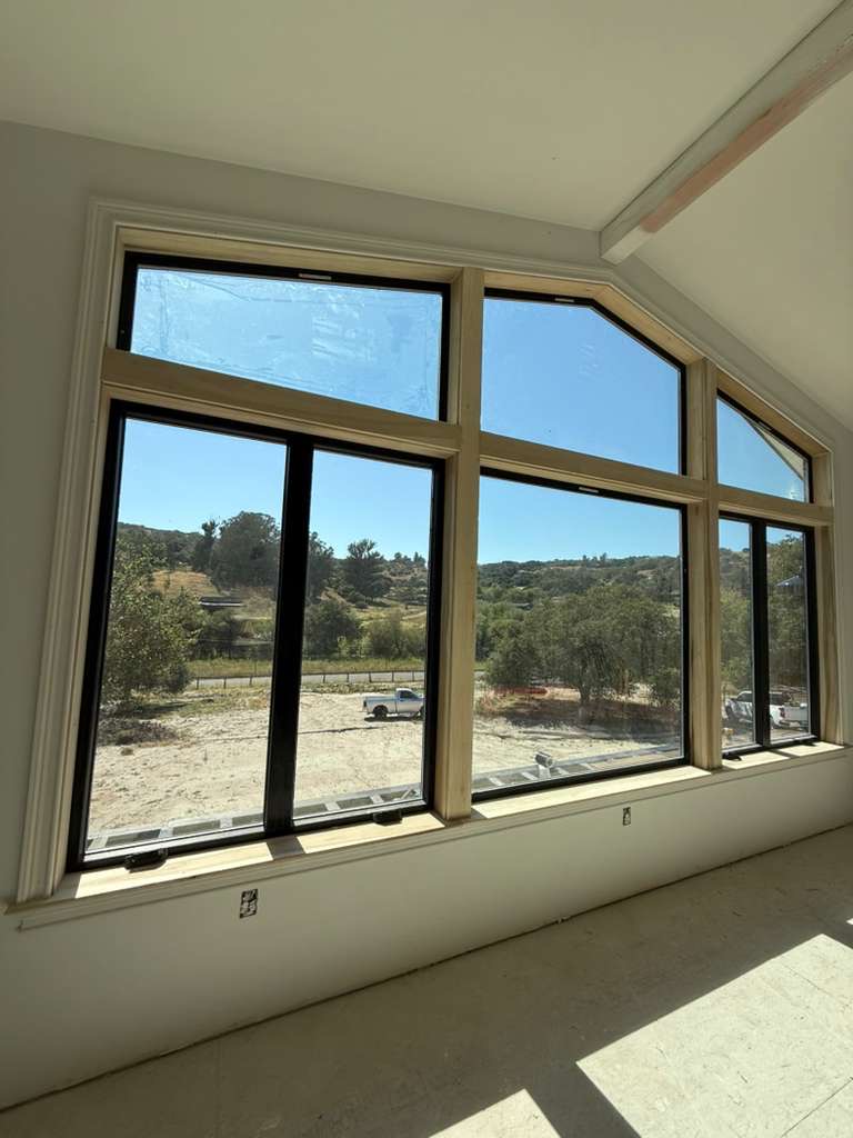 Custom window installation with hillside view